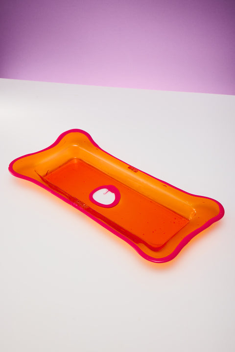 A rectangular orange and fuchsia resin tray.