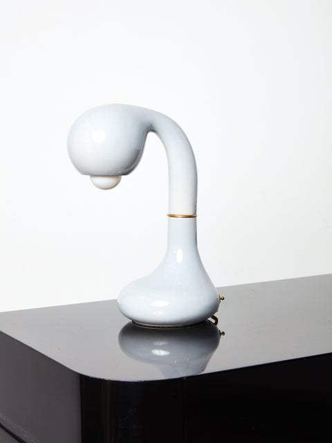 White Short Ceramic Table Lamp by Entler Studio on a glossy black surface.