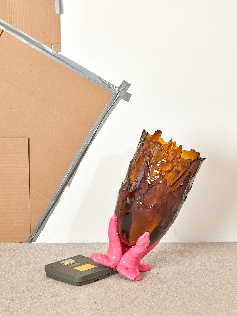 XXL Vessel in Brown Hot Pink with one of its feet perched up on the corner of a scale.