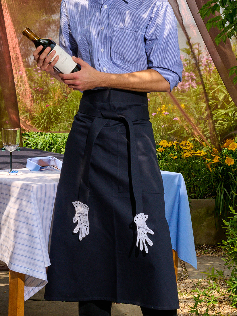 Someone holding a bottle of wine wears teh Apron with Lace Applique Hands by Gohar World.