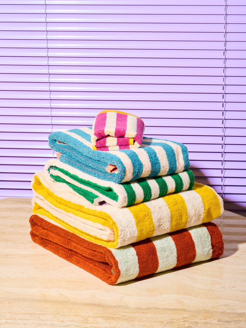 Neatly folded and stacked set of 5 Earth Stripe Bath and Hand Towels by Dusen Dusen showing their other side of colors.