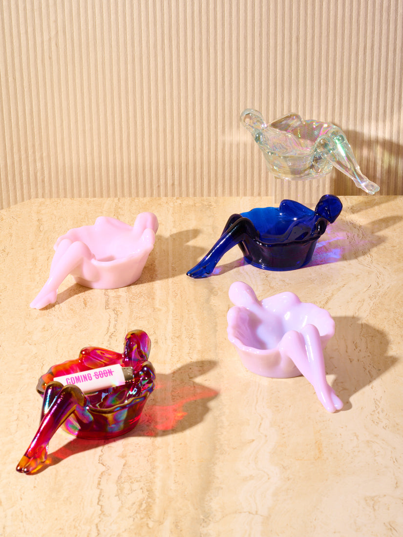 Bathing Lady dishes by Mosser in Iridescent Clear, Cobalt, Pink, Lavender, and Iridescent Red.