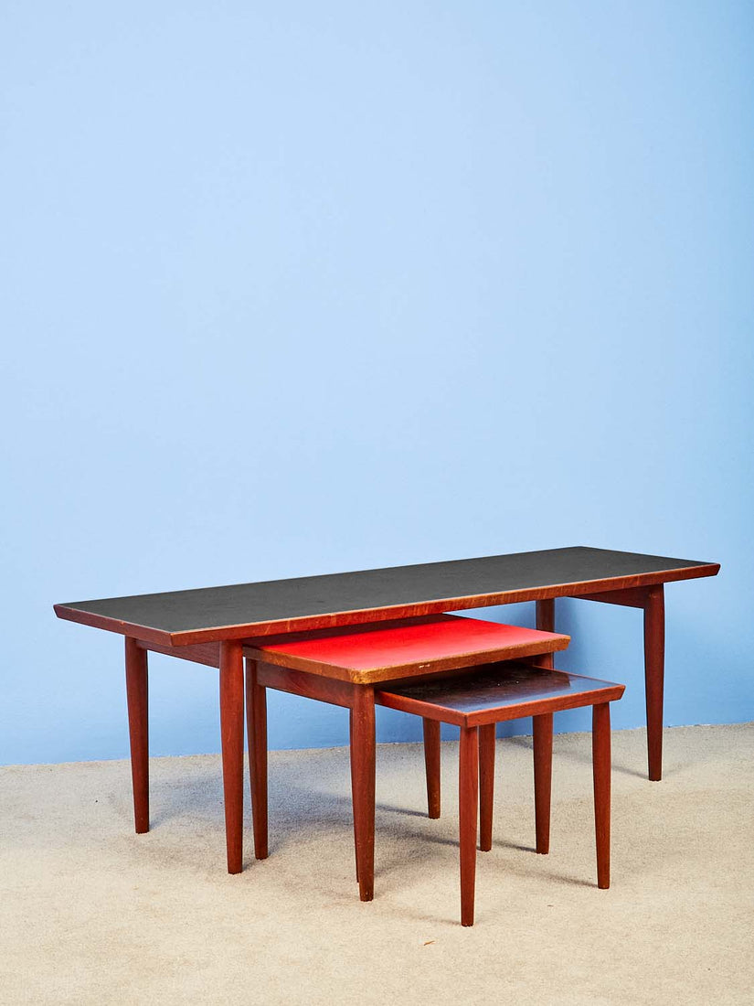 Three tables, black, red, and black - nesting out from each other.
