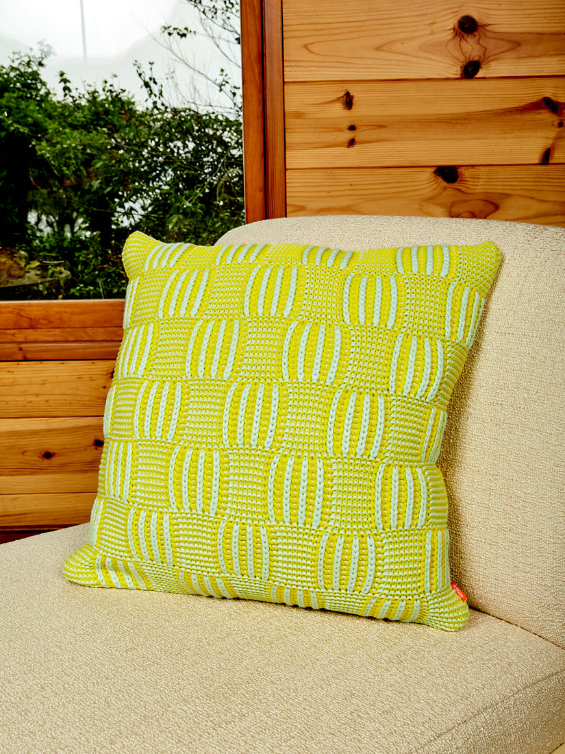 A Chunky Checkerboard Pillow by Verloop in lime green and pastel aqua.