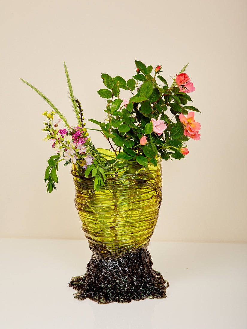 A floral bouquet in the Spaghetti Vessel in green.