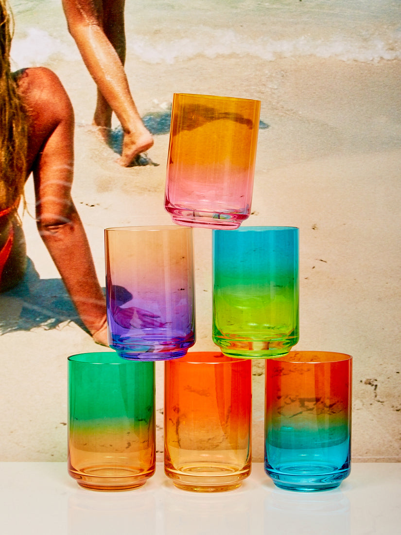 Pyramid stack of 6 different Gradient Glasses by Lateral Objects in front of a beach image.