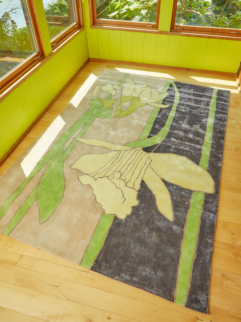 Disappearing Daffodil rug by Cold Picnic in a sunny green painted sunroom.