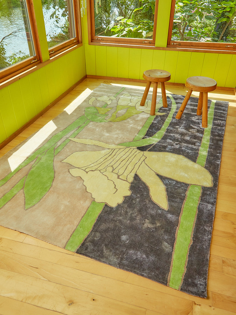 Disappearing Daffodil rug by Cold Picnic with two wooden stools atop.