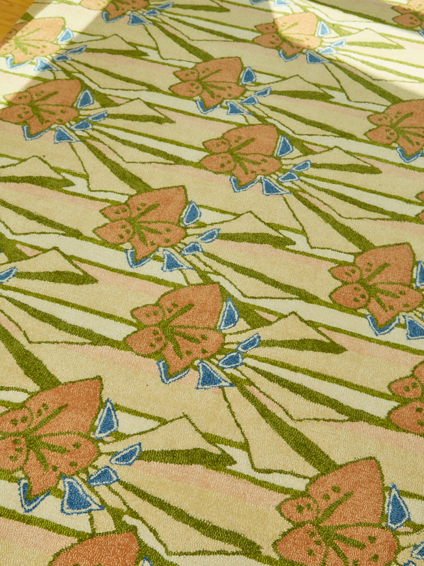 Close up of the abstract floral pattern with blue accents on the rug.