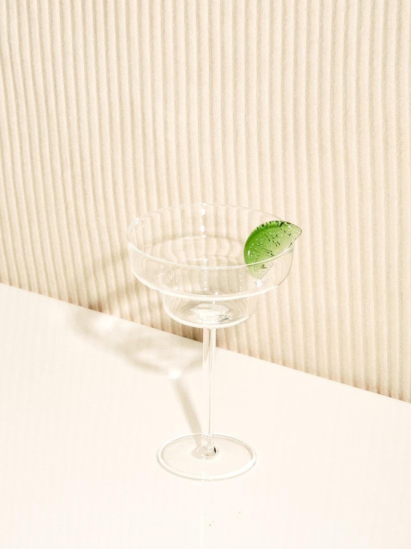 A Margarita Glass by Maison Balzac with a green glass permanent lime wedge.