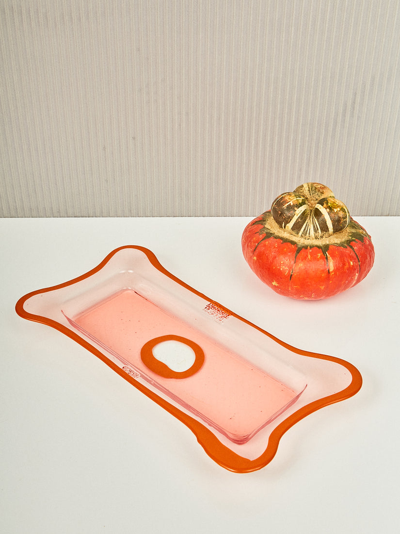 Peach and Pumpkin Rectangular Tray by Gaetano Pesce for Fish Design siting next to a pumpkin.