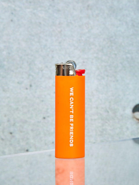 An orange Bic lighter with white text on it.
