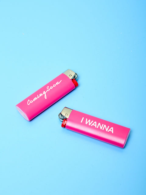 Two pink Bic lighters with the Coming Soon logo printed in white text.