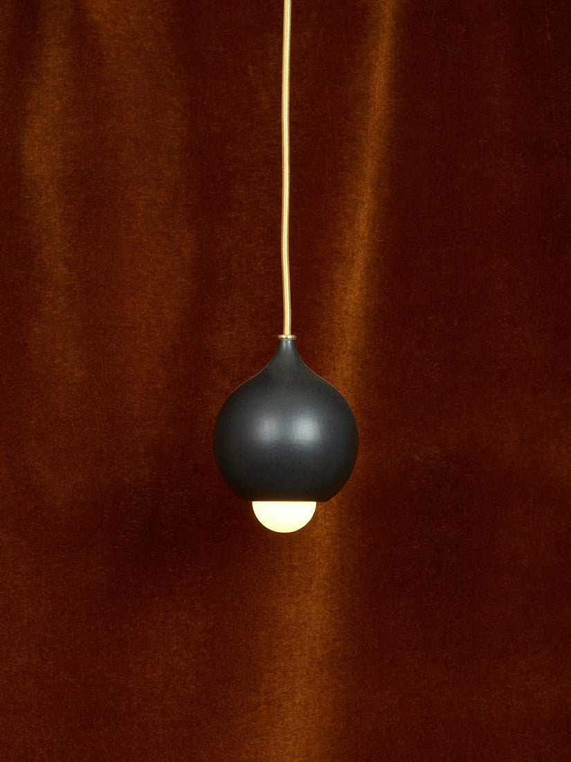 A matte black droplet pendant.