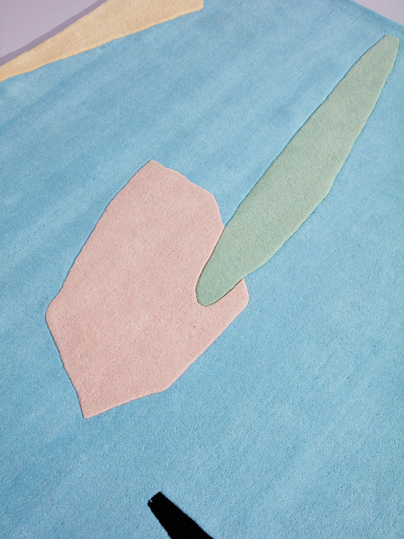 Close up picture of Coast to Coast rug showing light blue, sage and coral.
