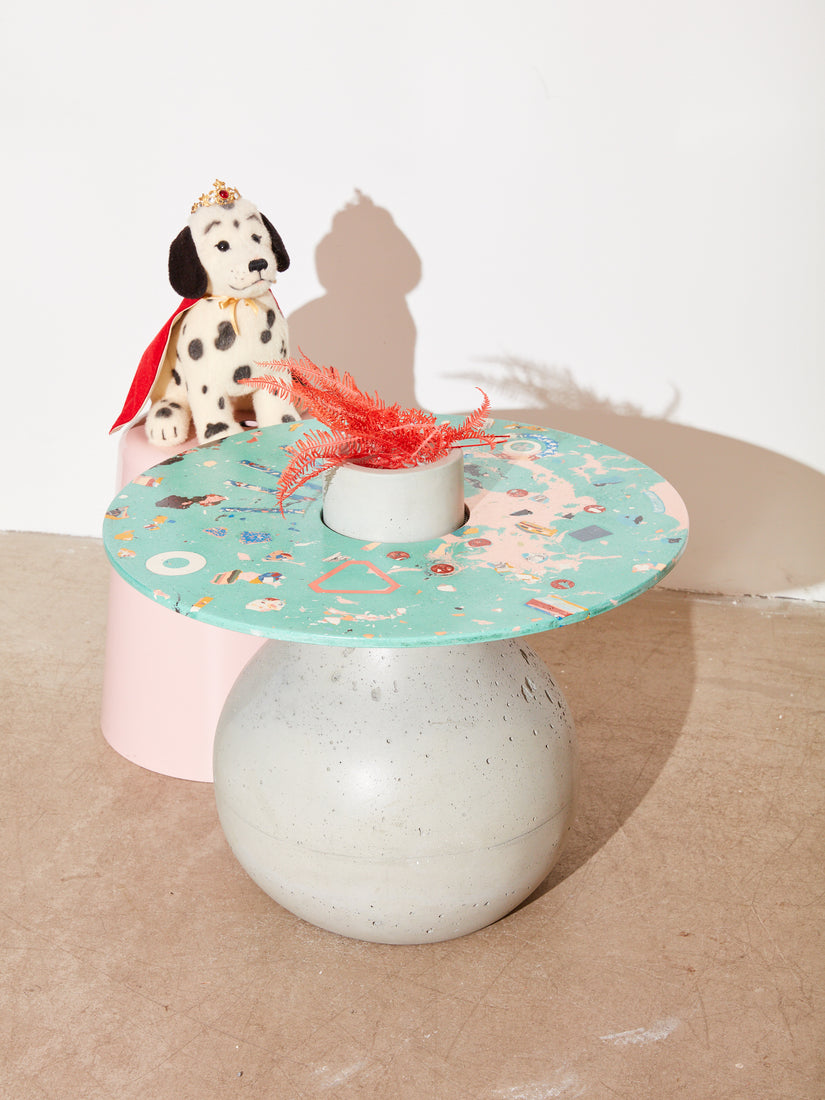 A stuffed dalmatian sits atop a pink stool behind the Venus Chaos Table.