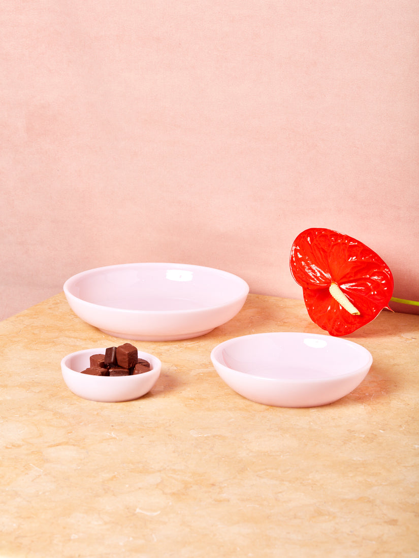 Pink Milk Glass Bowls by Mosser in small, medium and large. The small bowl is full of chocolate truffles.