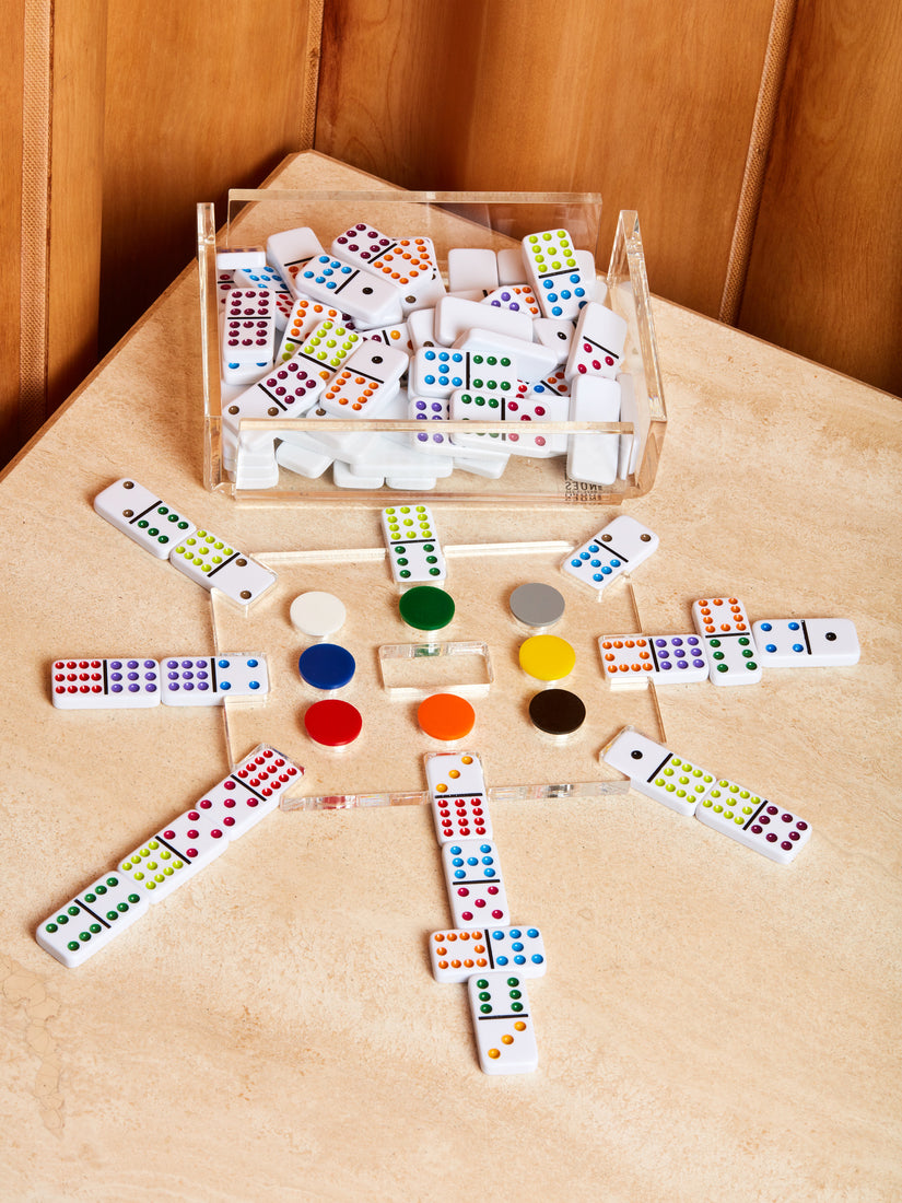 Mexican Train Game by Luxe Dominoes in play with its extra pieces in the clear acrylic case.