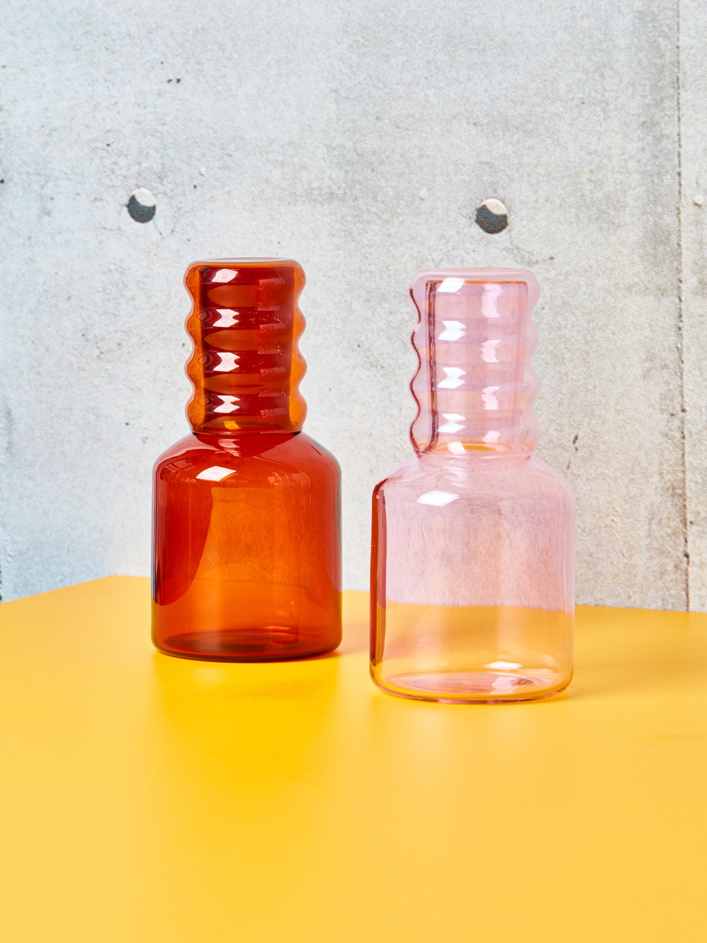 Pink and Amber bedside carafes with Ripple Cups by Sophie Lou Jacobsen.