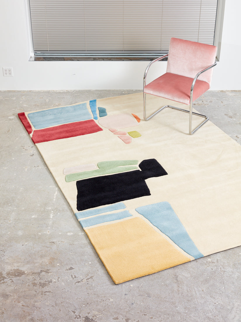 Cold Picnic's "From the Ferry" Rug in 6x9 sits on a concrete floor with a pink Brno chair atop.