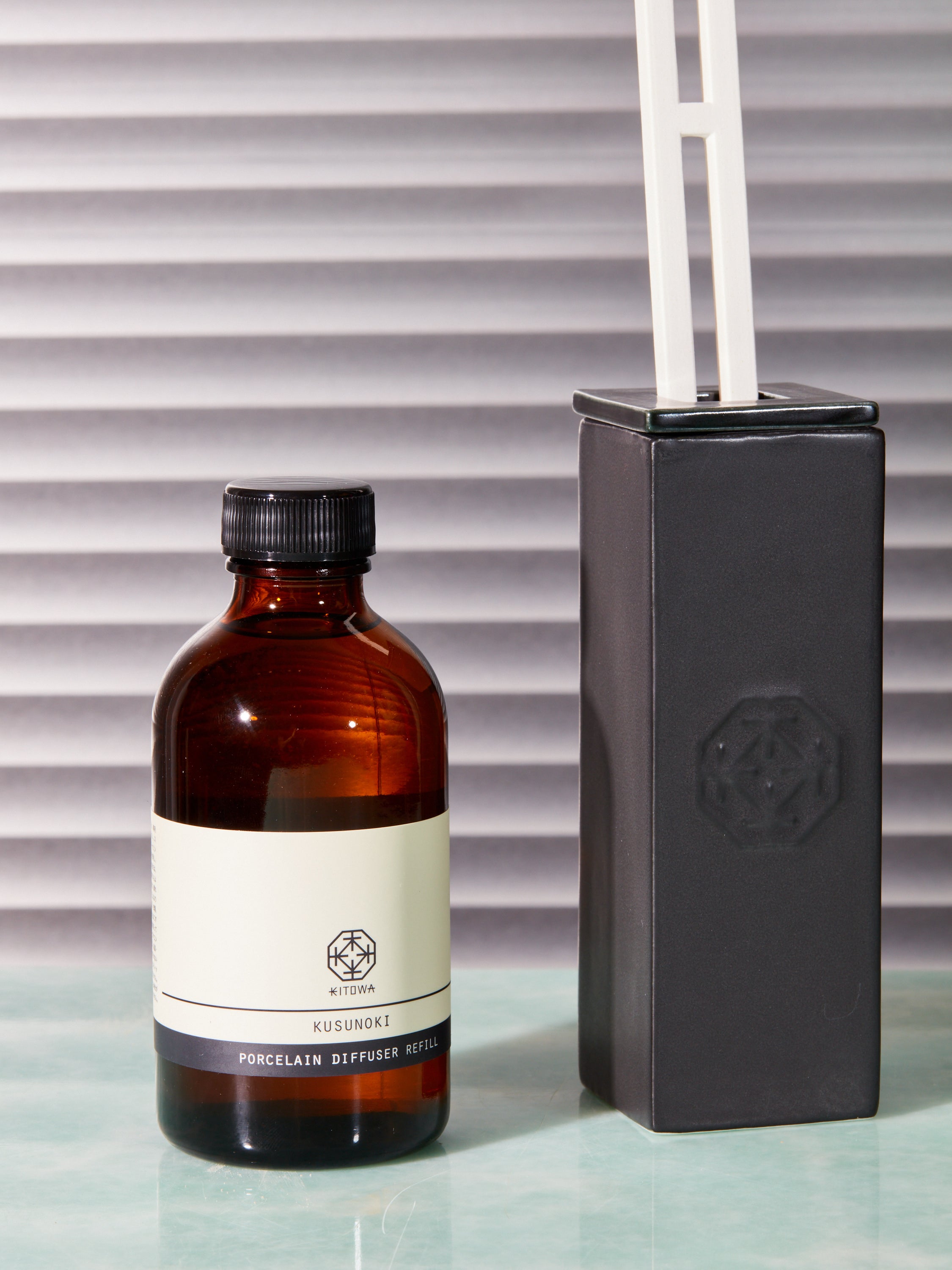 Porcelain aroma diffuser by Kitowa next to a refill bottle.