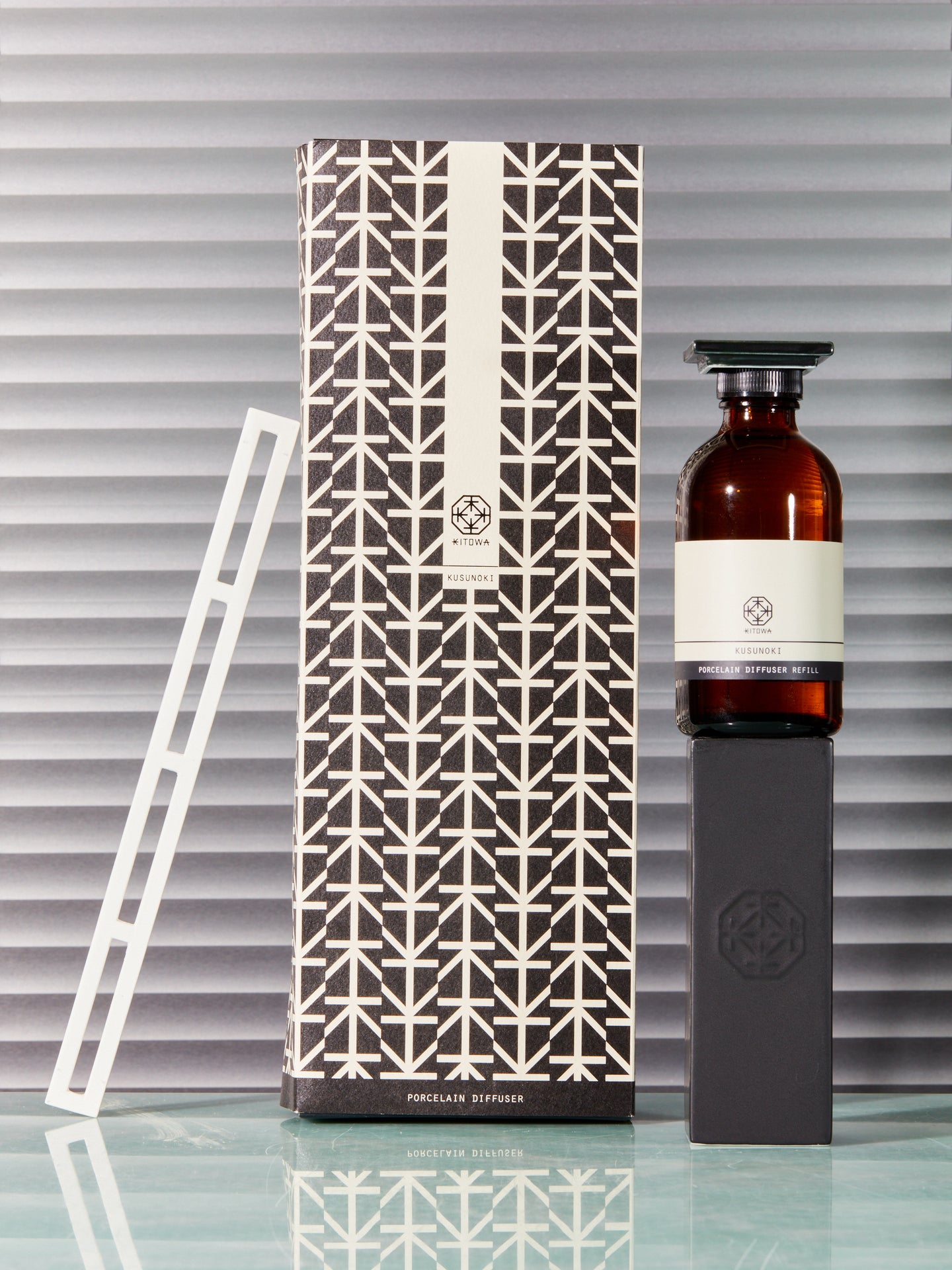 An artisitic stack of Kitowa Porcelain Diffuser, refill oil, and its packaging.