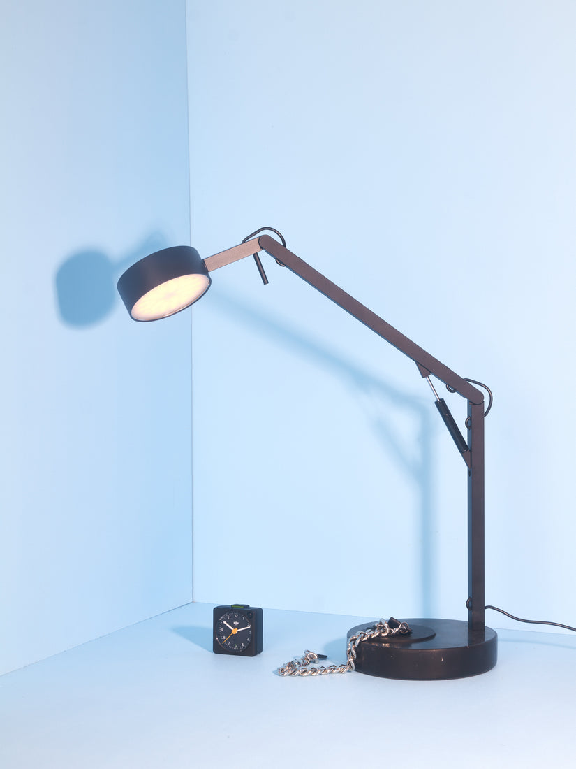Black Strut Lamp, a chain, and a Braun travel alarm clock.