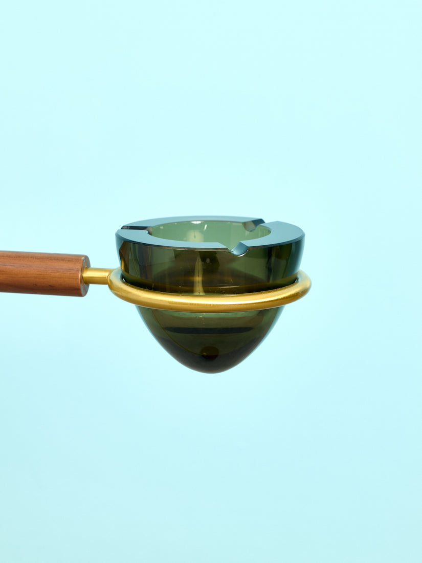 Close up of the smoke glass vessel of the Standing Ashtray sitting in its brass ring holder.