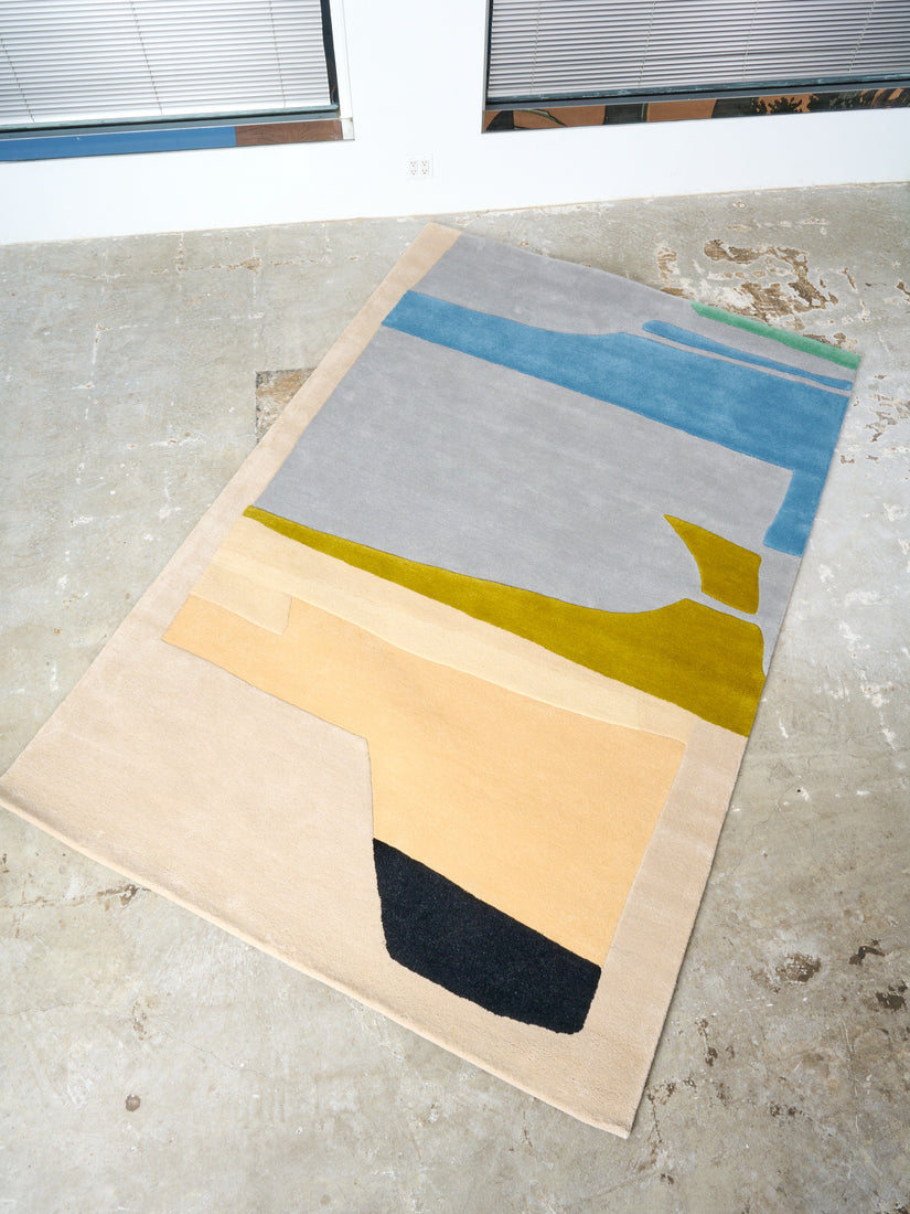 The Desert and the Sea Rug by Cold Picnic in 6x9 on a concrete floor.