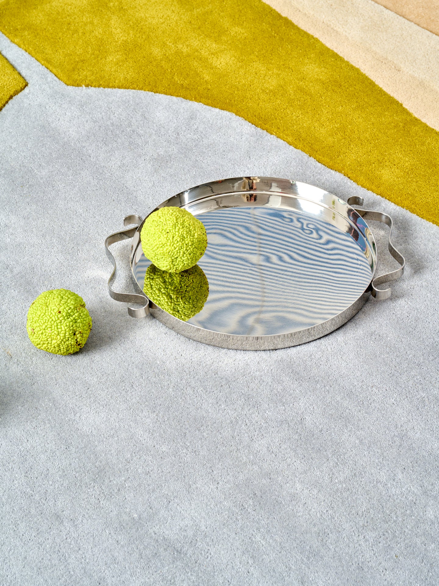 The Squiggle Tray by Sophie Lou Jacobsen atop an abstract rug.