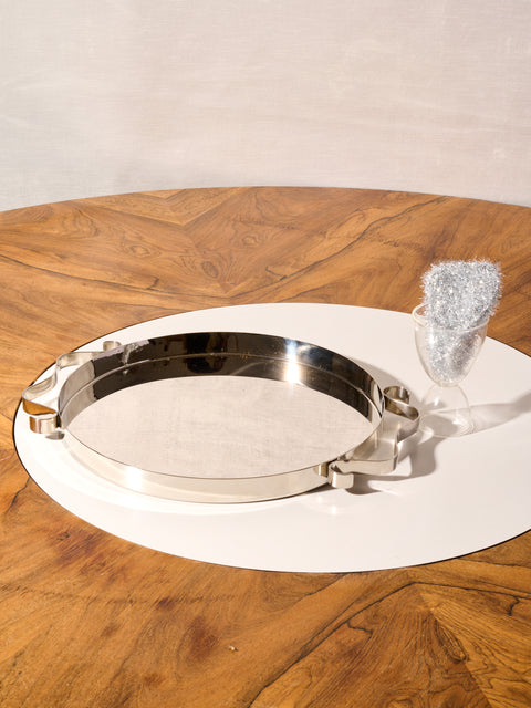 A Squiggle Tray by Sophie Lou Jacobsen, a clear cocktail glass, and a silver Sponge.