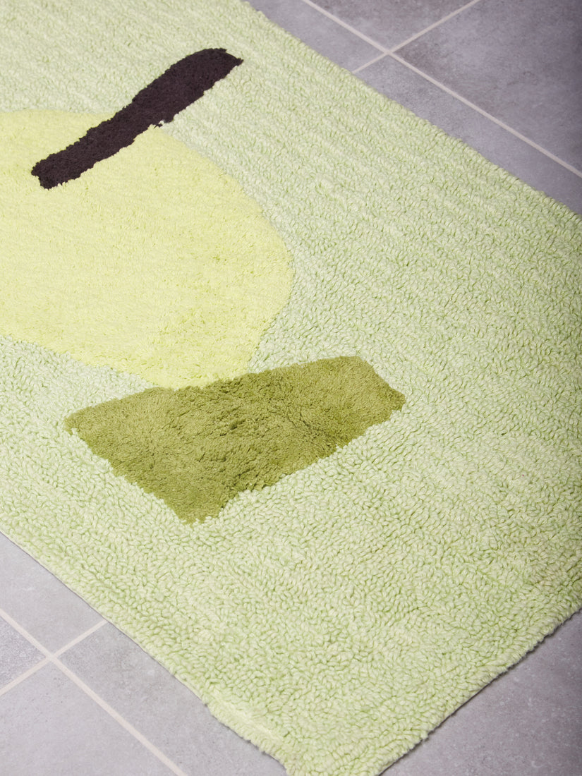 Mostly green bath mat with an accent of black, paler green, and darker green.