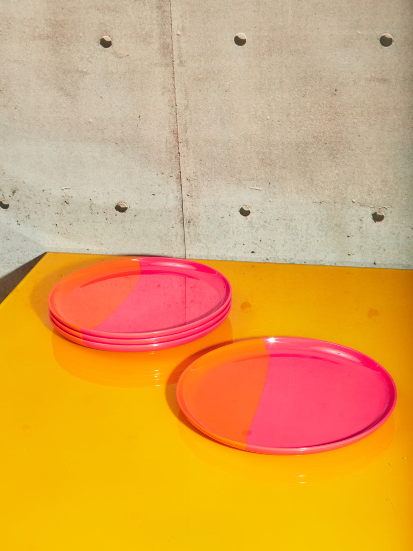 A set of 4 orange and pink melamine plates.