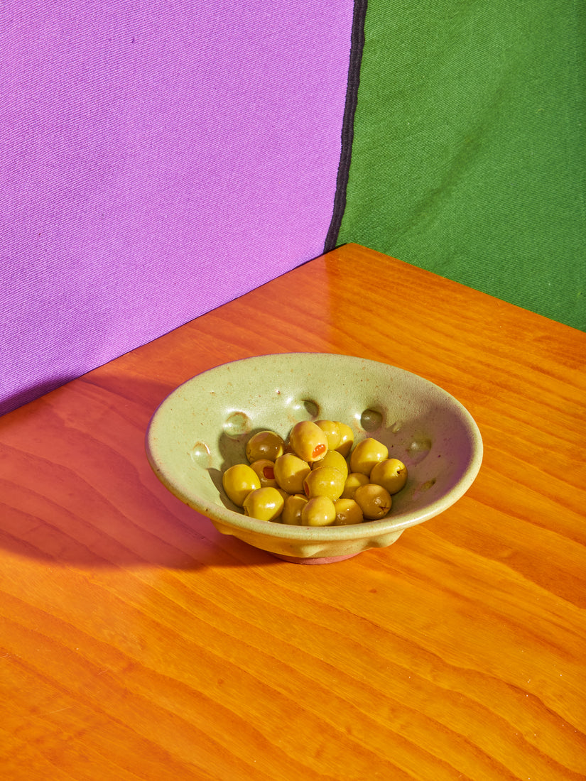 Small Olive Dimpled Ceramic Bowl by Valtierra Ceramica full of olives.