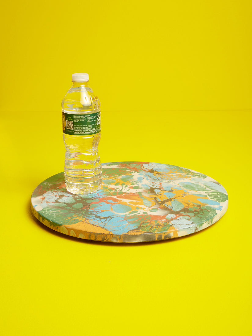 A plastic water bottle sits atop a Concrete Cat lazy susan.