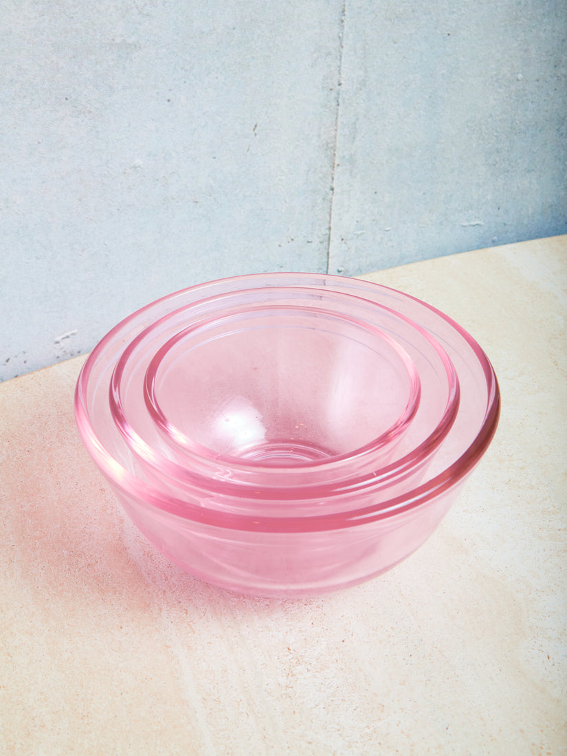 Set of 3 nesting transparent pink glass bowls.