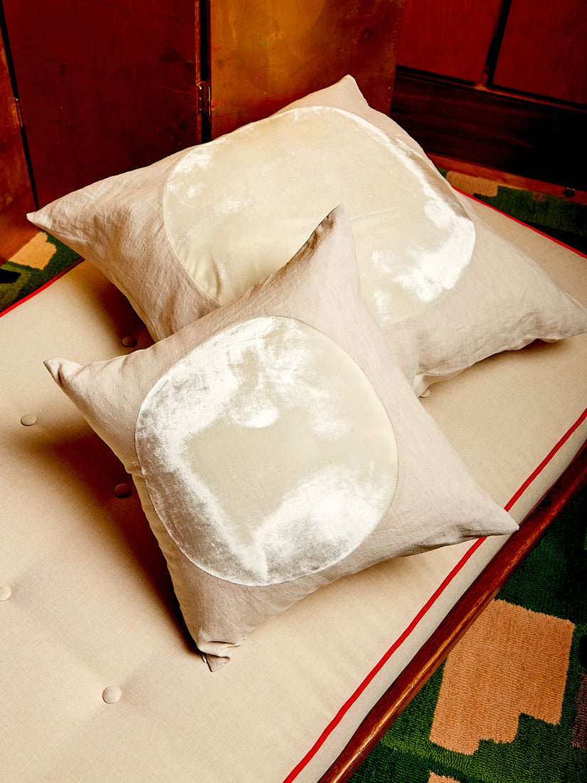 An ivory medium and large Velvet Circle Pillow.