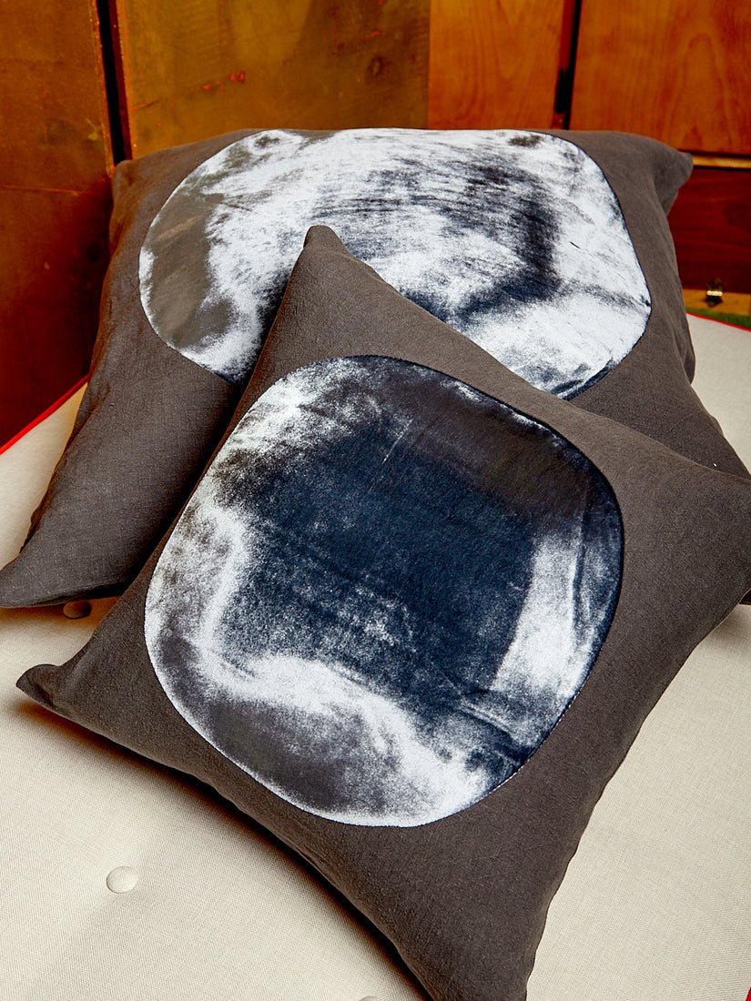 A charcoal medium and large Velvet Circle Pillow.