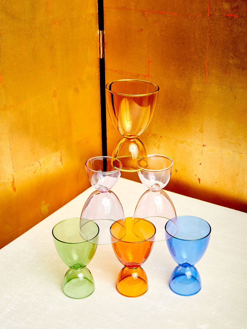 A pyramid of Mamo's cocktail glasses in 6 different monotone colorways.