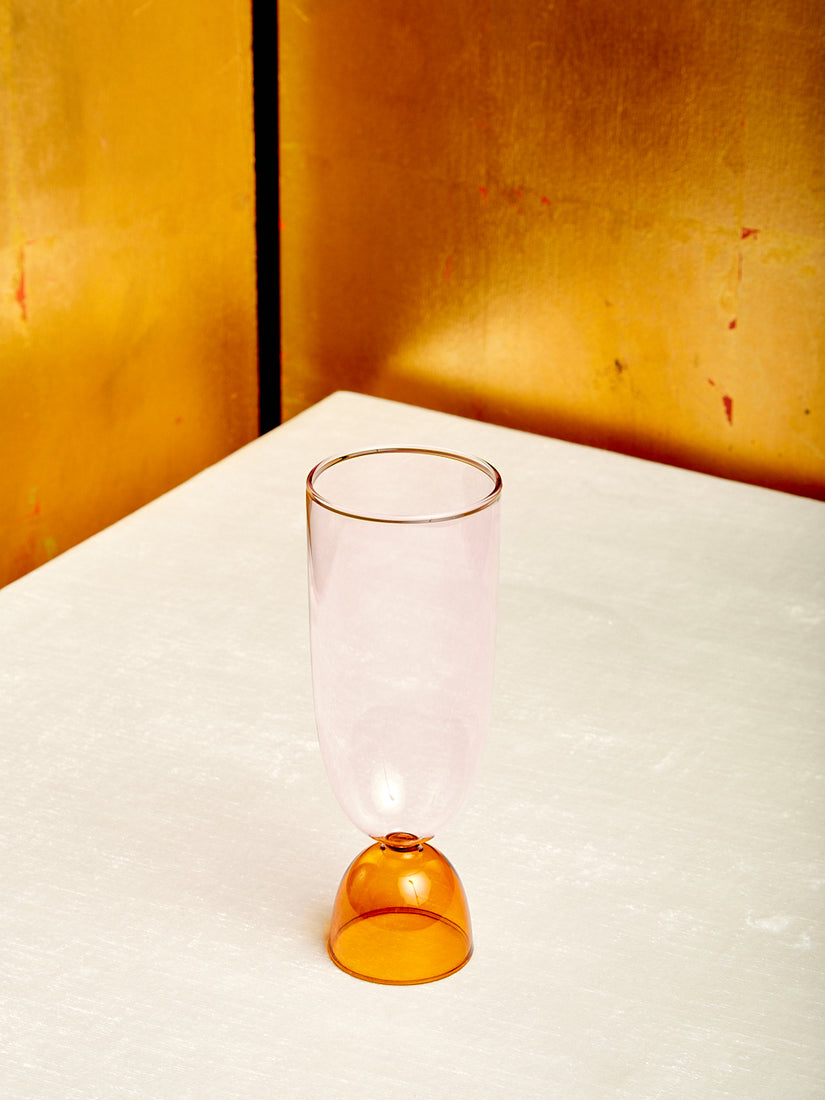 A pink top amber bottom Harry Highball Glass.