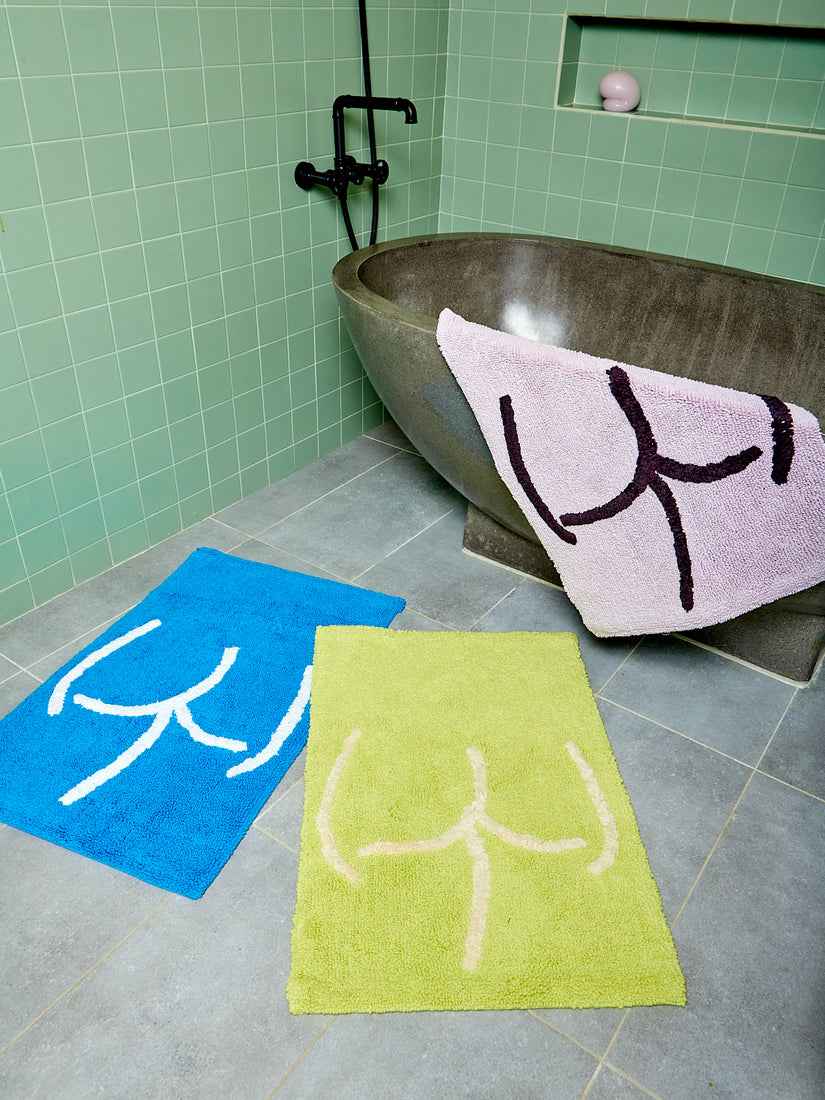 Tushy Bath Mat's in blue, lavender, and highlighter by Cold Picnic.