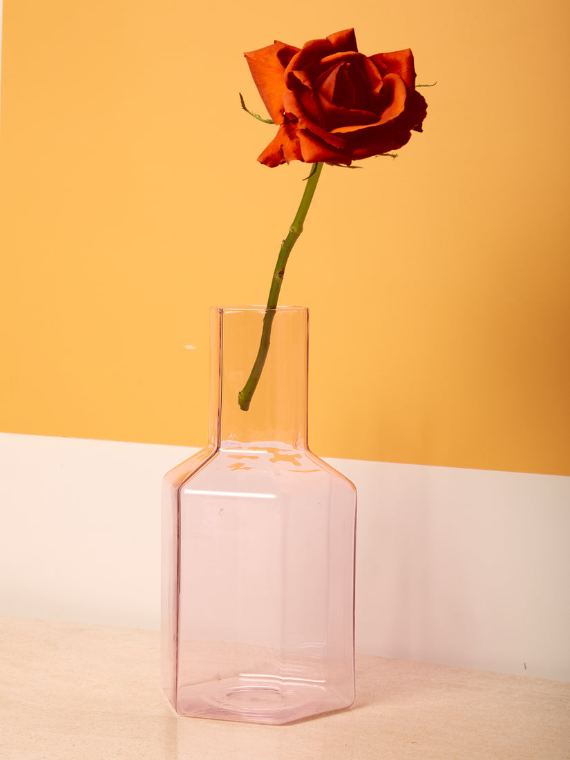 A pink Coucou Decanter by Maison Balzac with a single rose.
