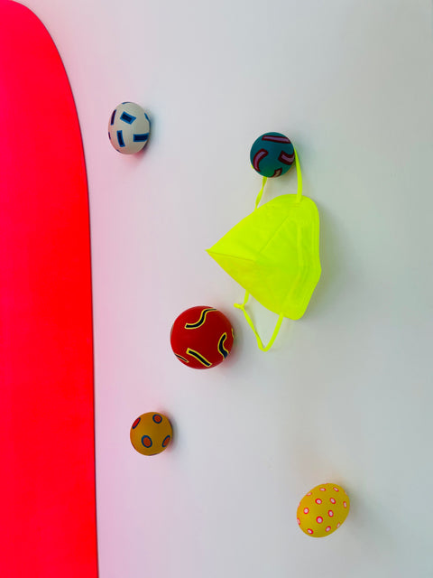 Chiaozza Wall Hook set mounted on a the wall with a neon green mask hanging on one hook.