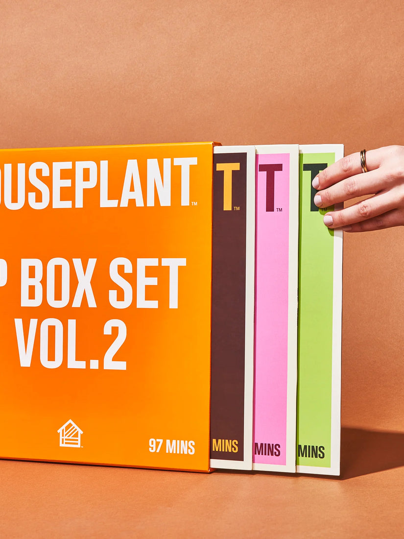 A hand reached for a green vinyl sleeve from the Houseplant LP Box Set Vol 2.