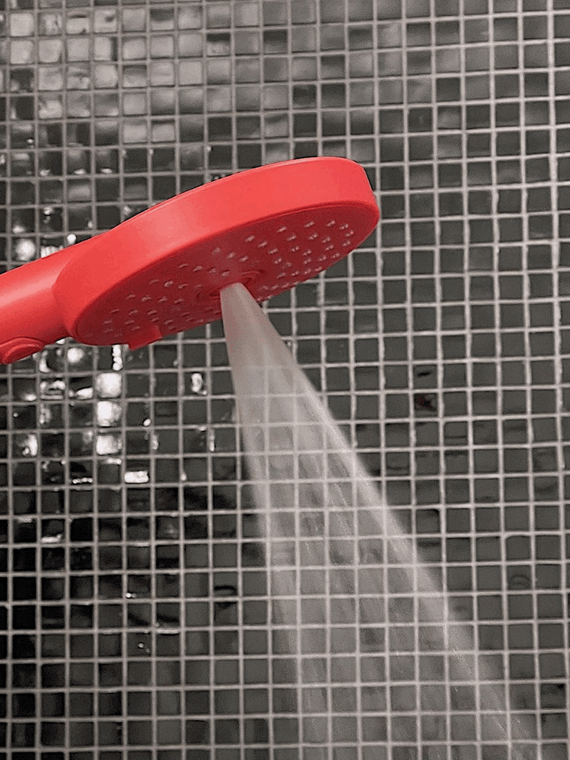 Three different spray settings demonstrated by a red hand shower.