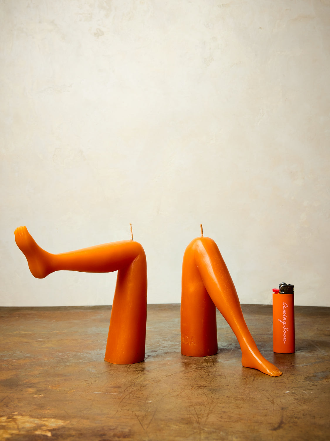 A pair of orange leg candles by Dada.