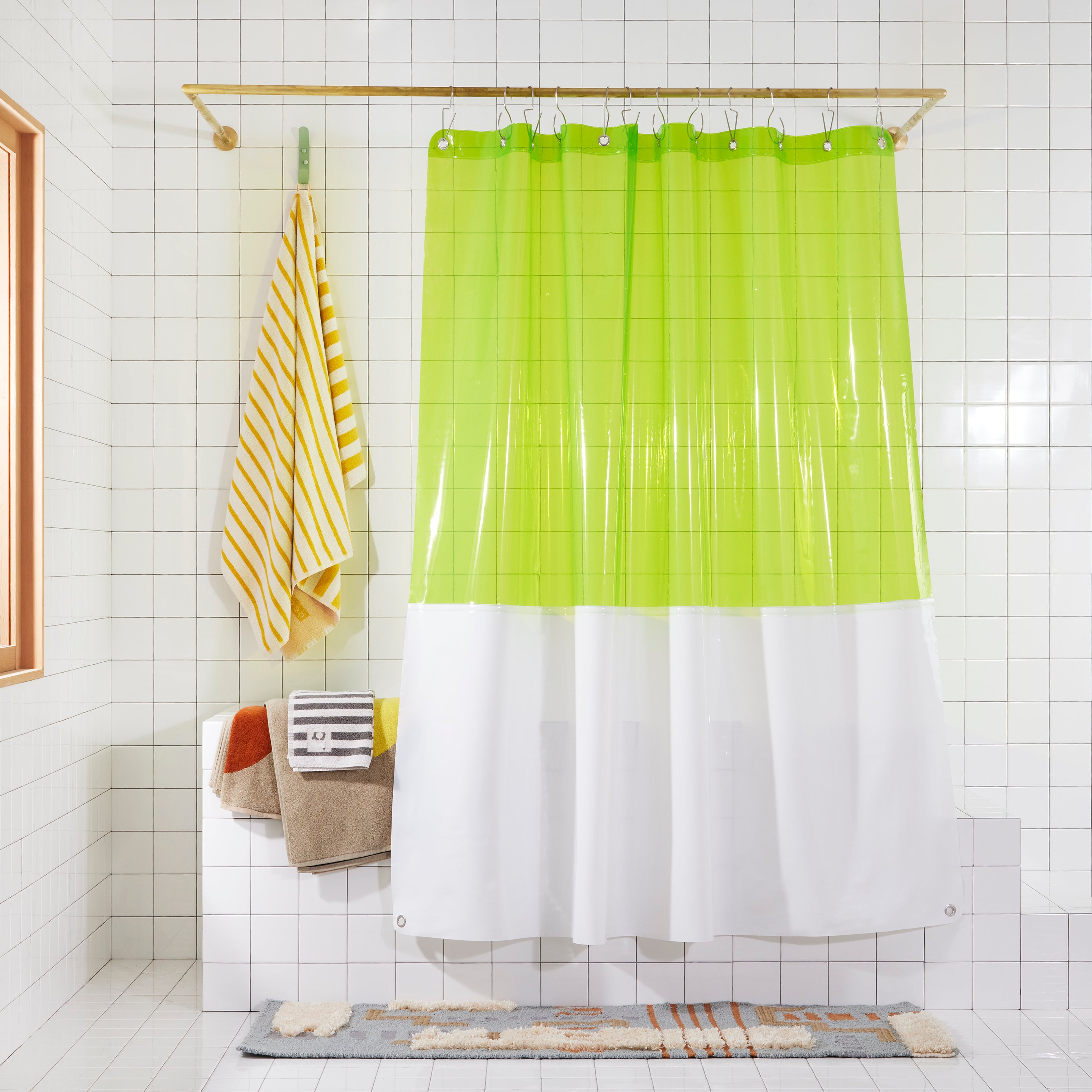 The Zinc Sun Shower Curtain hanging in a white tiled bathroom.