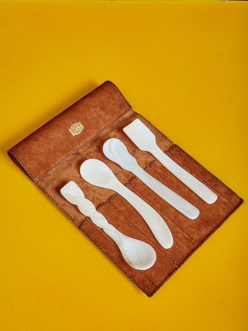 Set of four Mother of Pearl Dessert Spoons by Gohar World laying on their leather pouch.