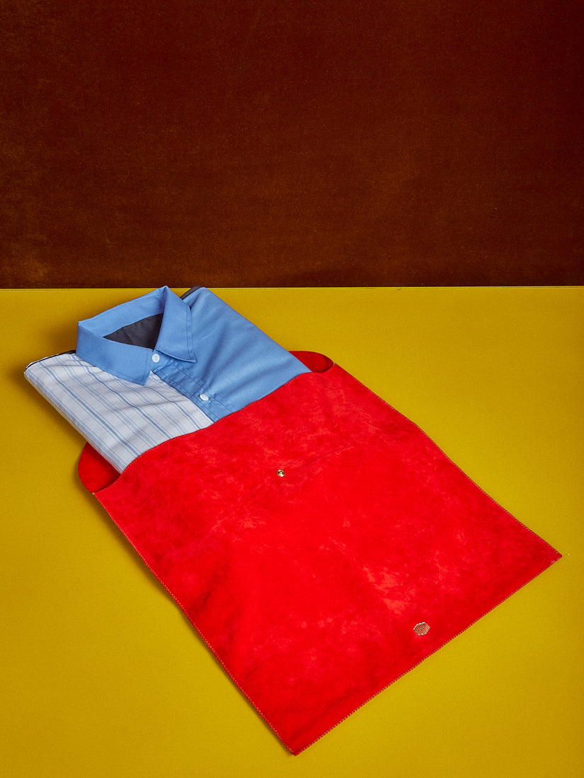 A Shirt Tablecloth II folded and neatly peeking out of its red suede pouch.