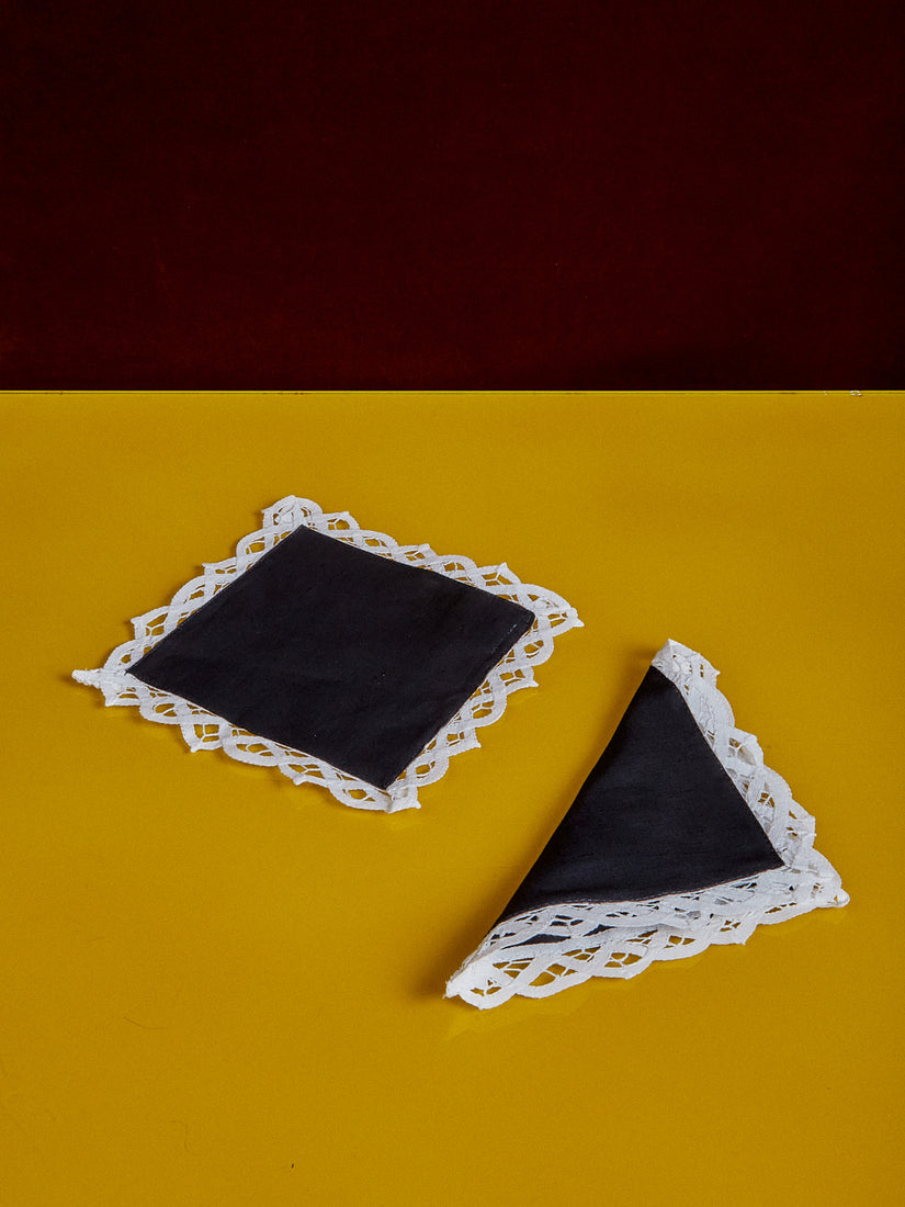 Lace Trim Cocktail Napkins by Gohar World. Black square napkins with a white lace trim.
